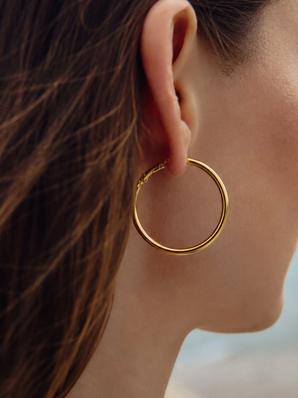 Model wearing Daily Hoop Classic gold hoop earrings
