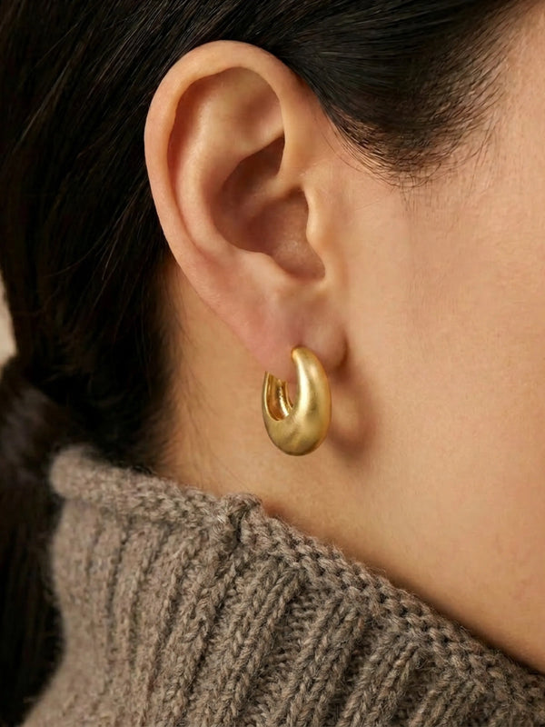 Model wearing Daily Hoop Dome chunky gold hoop earrings