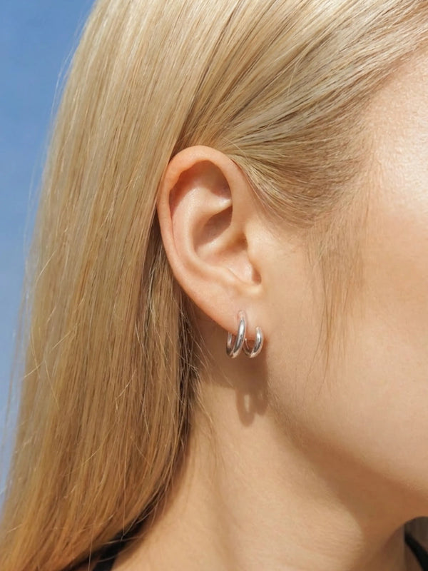 Model wearing Daily Hoop Duo silver hoop earrings